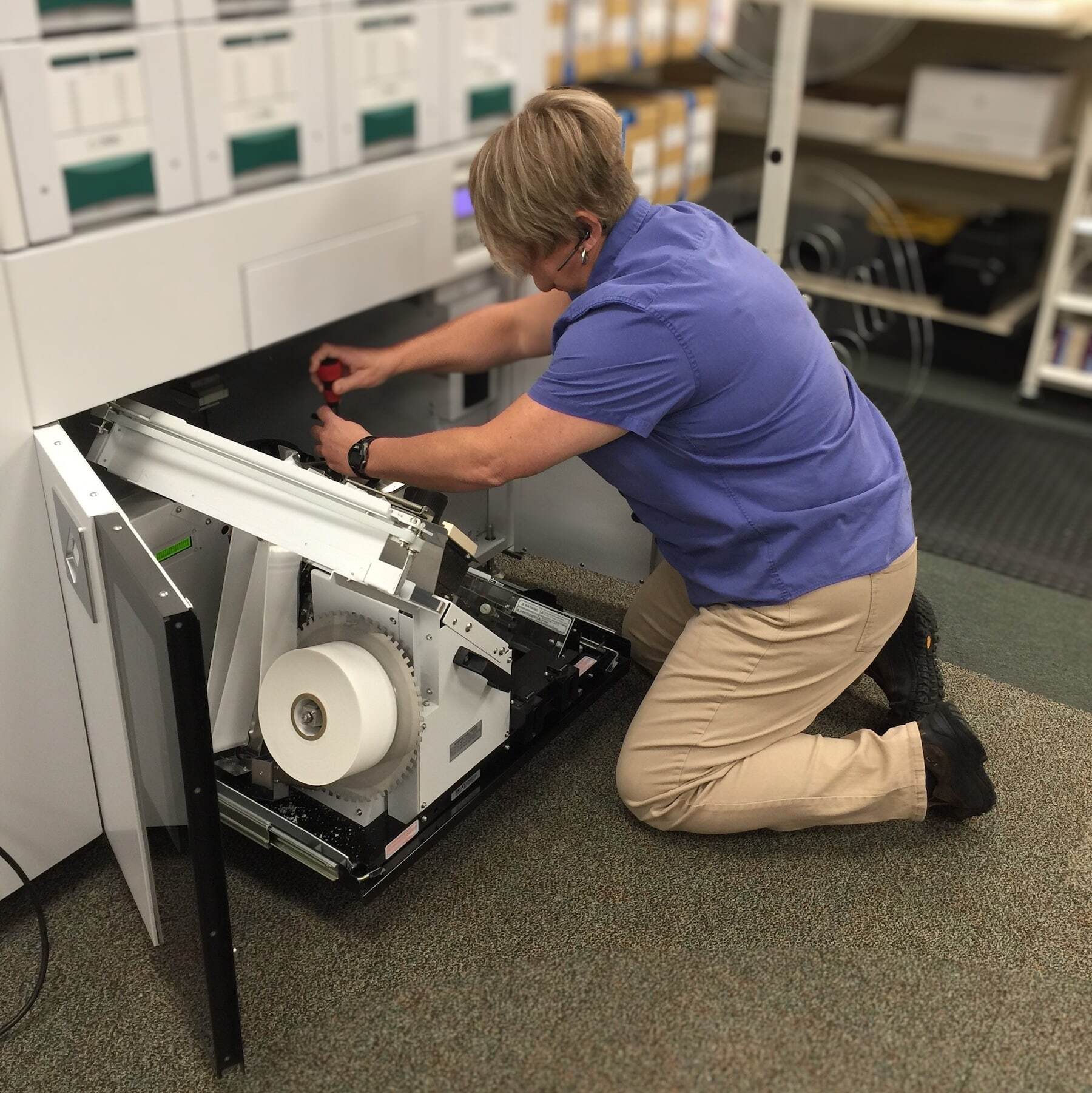 MERA employee repairing equipment